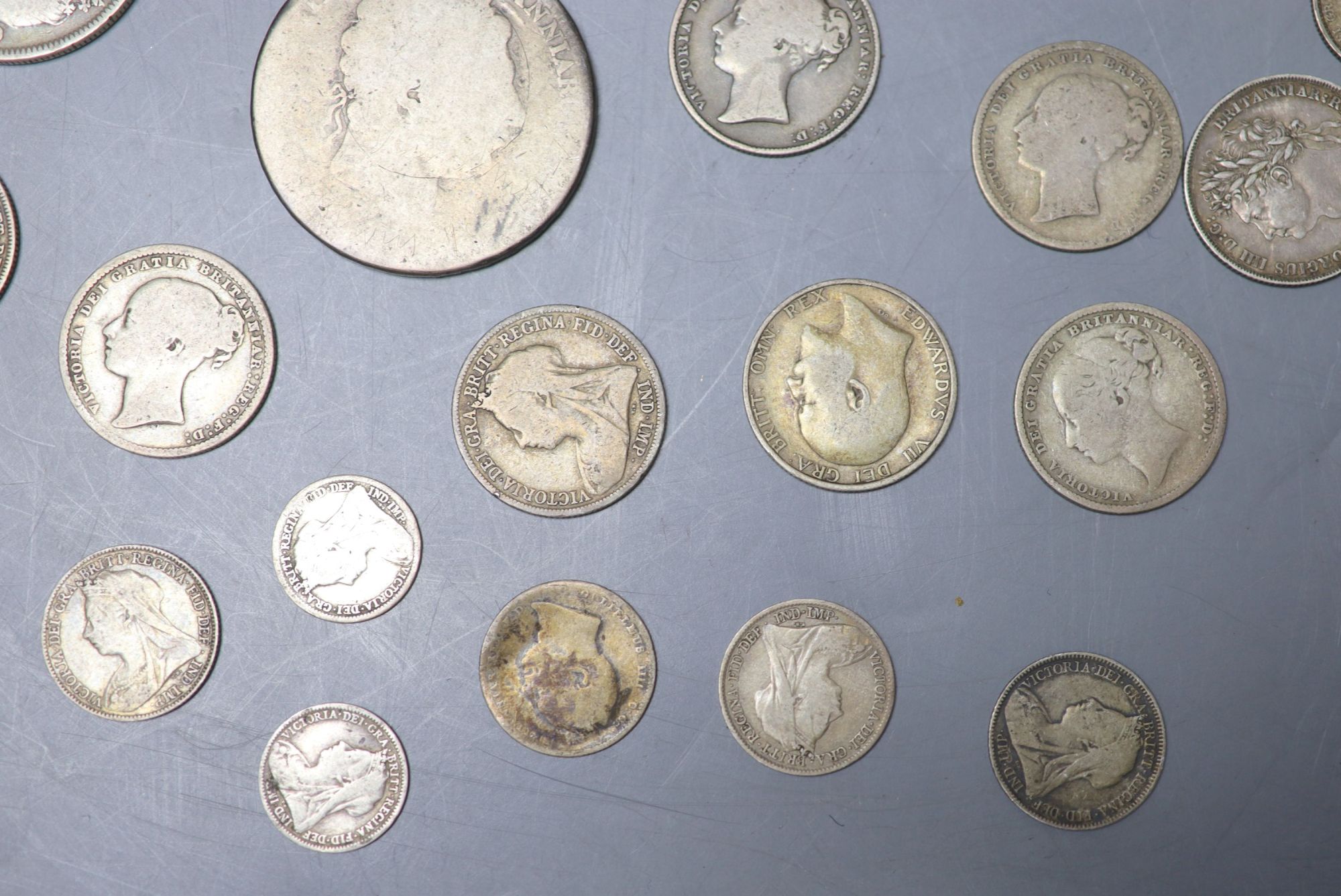 A collection of UK and world coins including George IV - George V silver threepences to halfcrowns